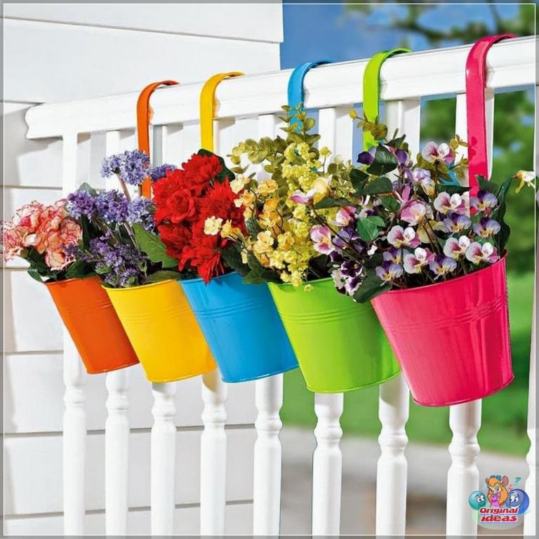 Colorful buckets with flowers add bright colors to your garden